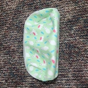 green llama bathroom bag with silver zipper